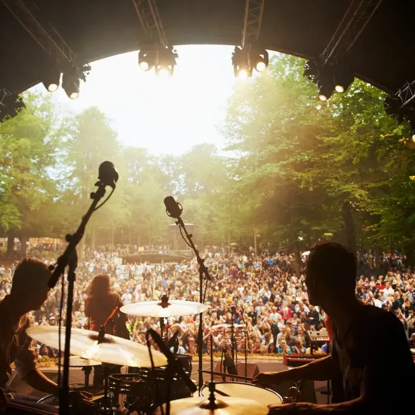 Looking out into the crowd of a festival, behind the drummer.